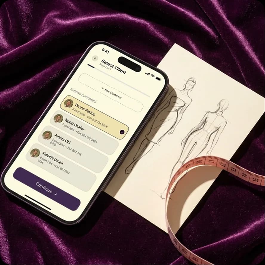 Select client screen beside a fashion sketch and measuring tape